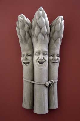 Three asparagus stalks with faces