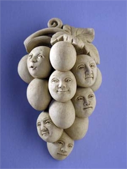 Bunch of grapes, some with human faces